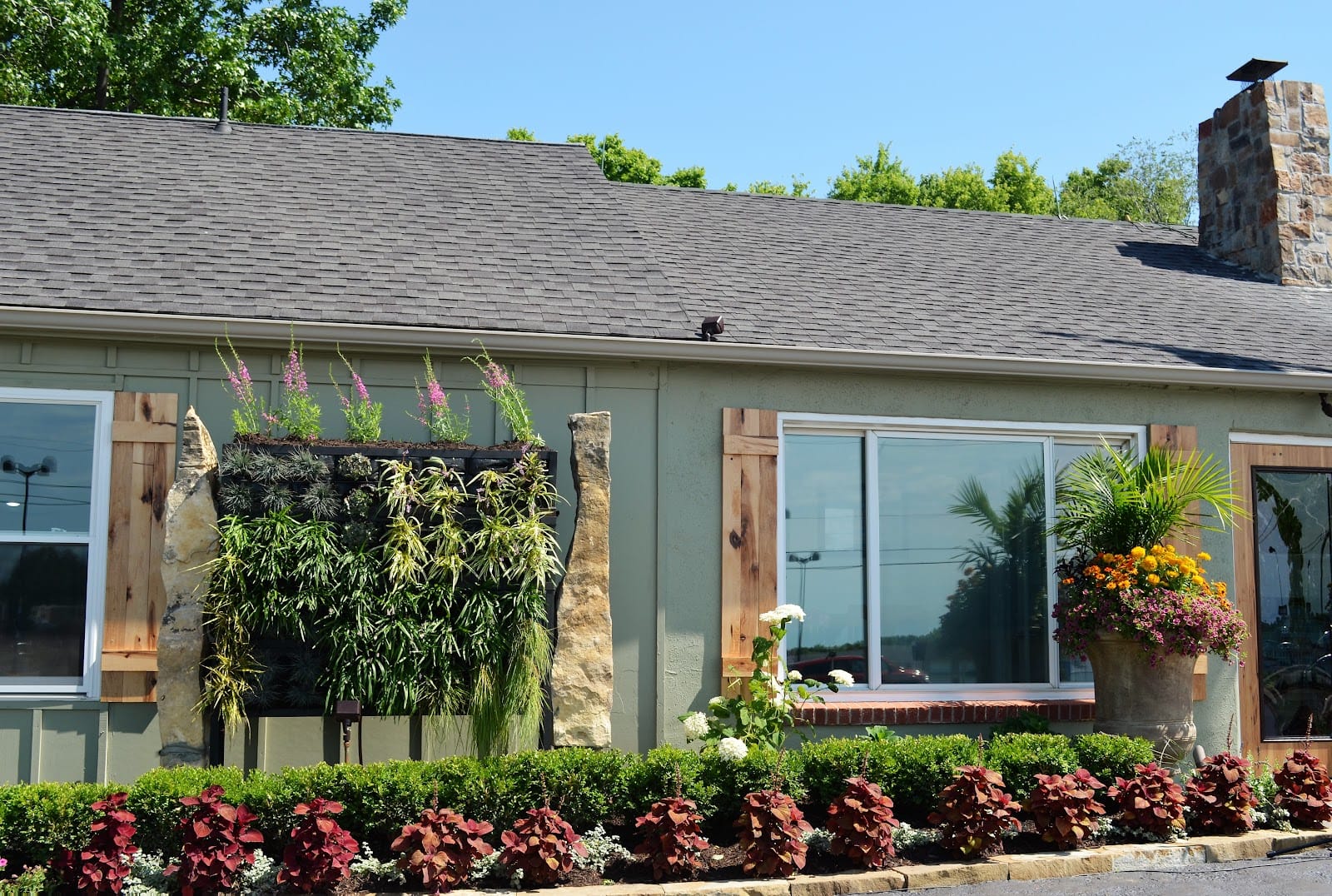 Fresh landscape beds and foundation plantings across the front of a Parkville-area home