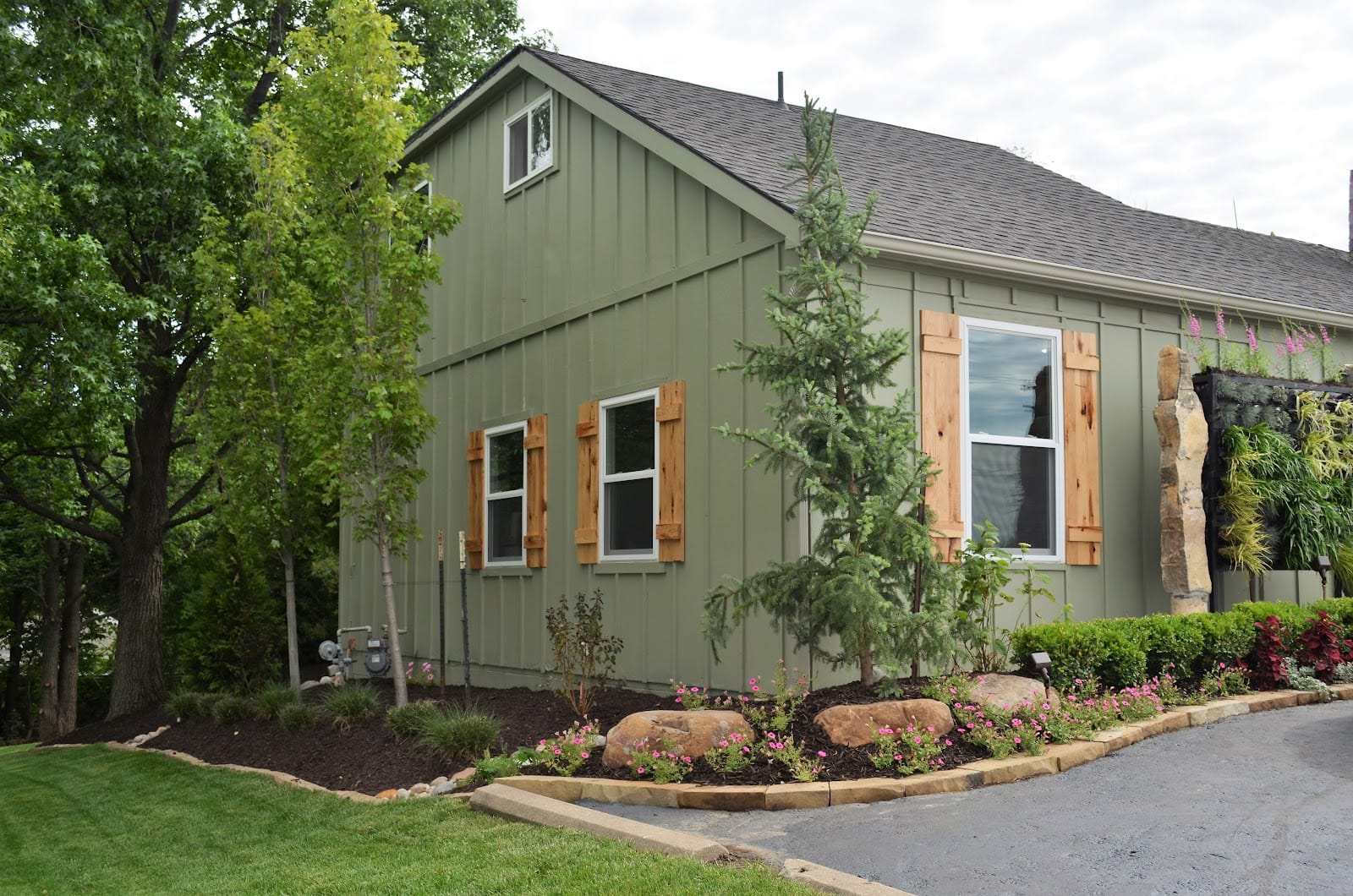 A thick green lawn wrapping a landscaped Kansas City home